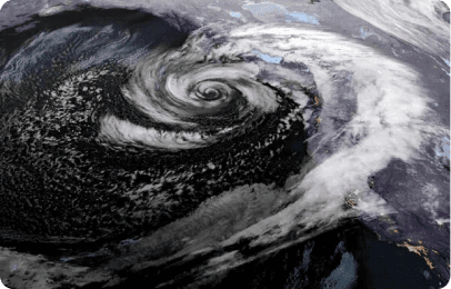Satellite view of a large swirling hurricane storm over the ocean.